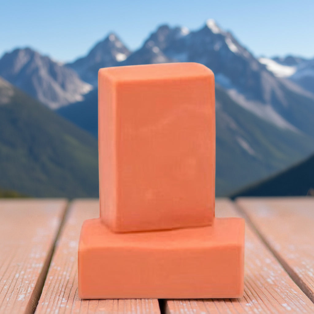 Orange rectangular soap bar stacked on another bar of soap 